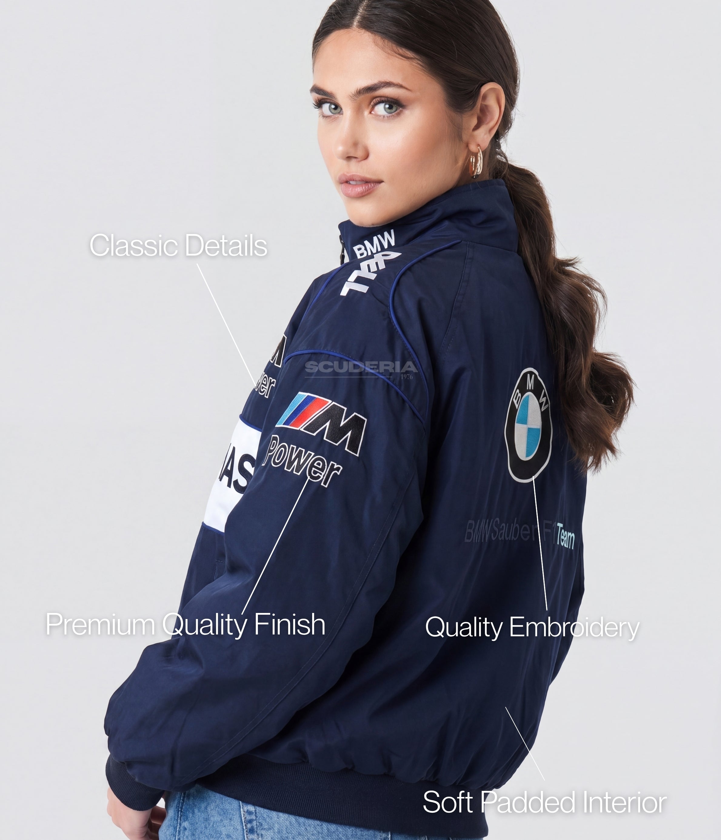 Woman wearing a navy blue BMW jacket with various logos on a white background