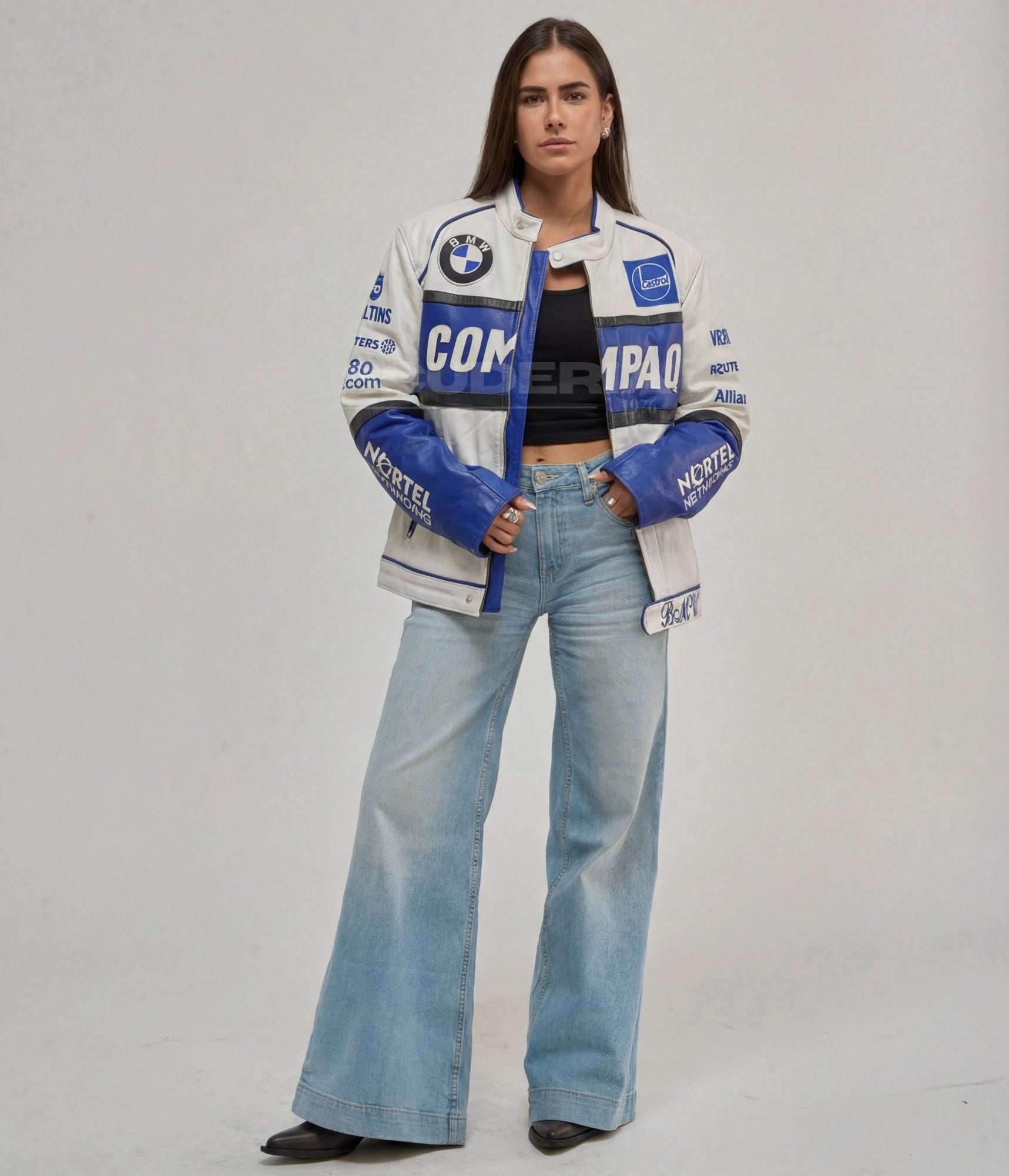 BMW Vintage Leather Jacket white blue full body view women – vintage moto leather jacket with Compaq chest panel, BMW roundel patch, Castrol and Nortel Networks patches, blue sleeves, styled with wide-leg flare jeans
