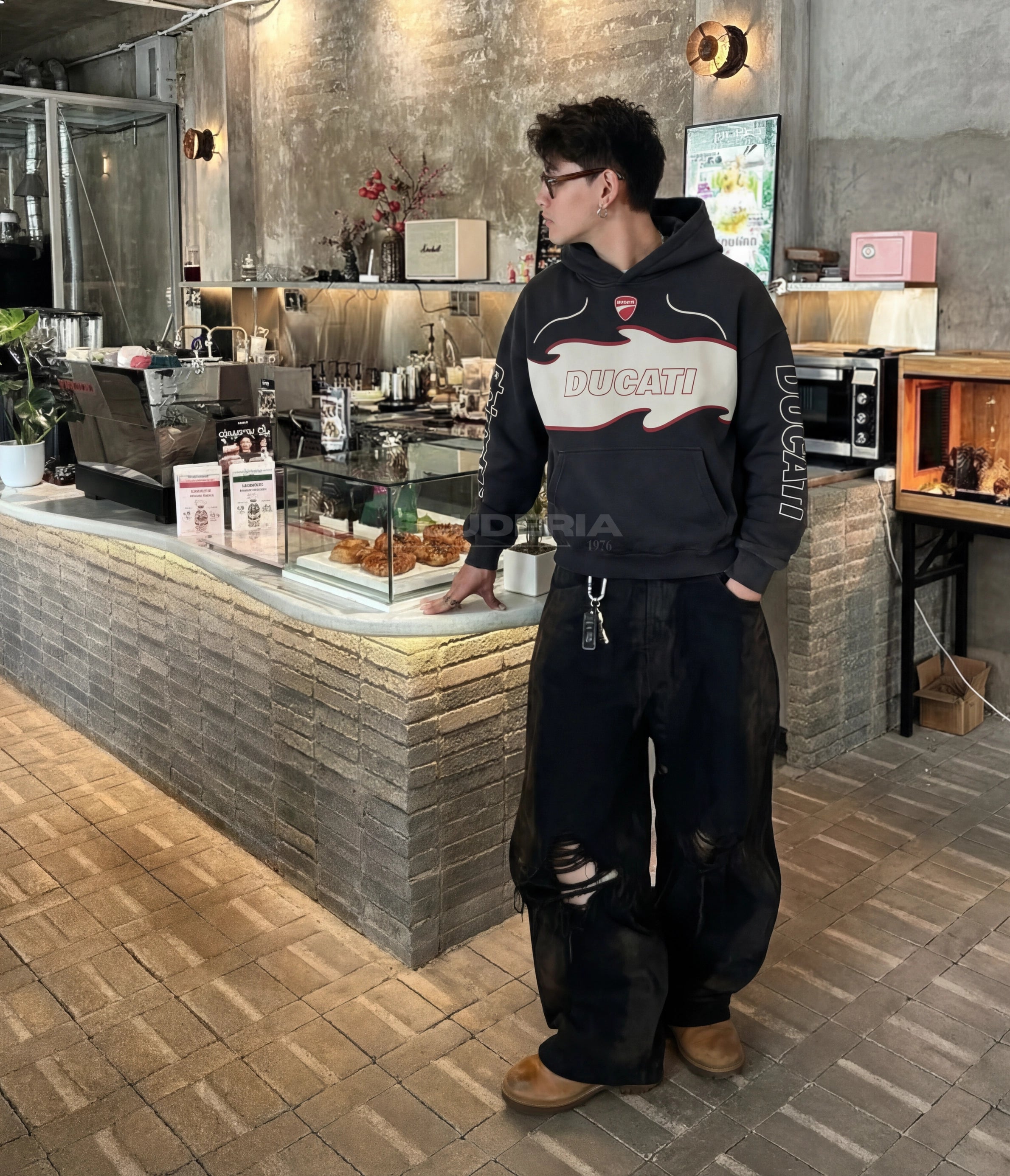 Ducati Alpinestars Racing Hoodie black washed lifestyle man – vintage oversized motorsport sweatshirt with Ducati chest logo styled with ripped baggy jeans inside a coffee shop