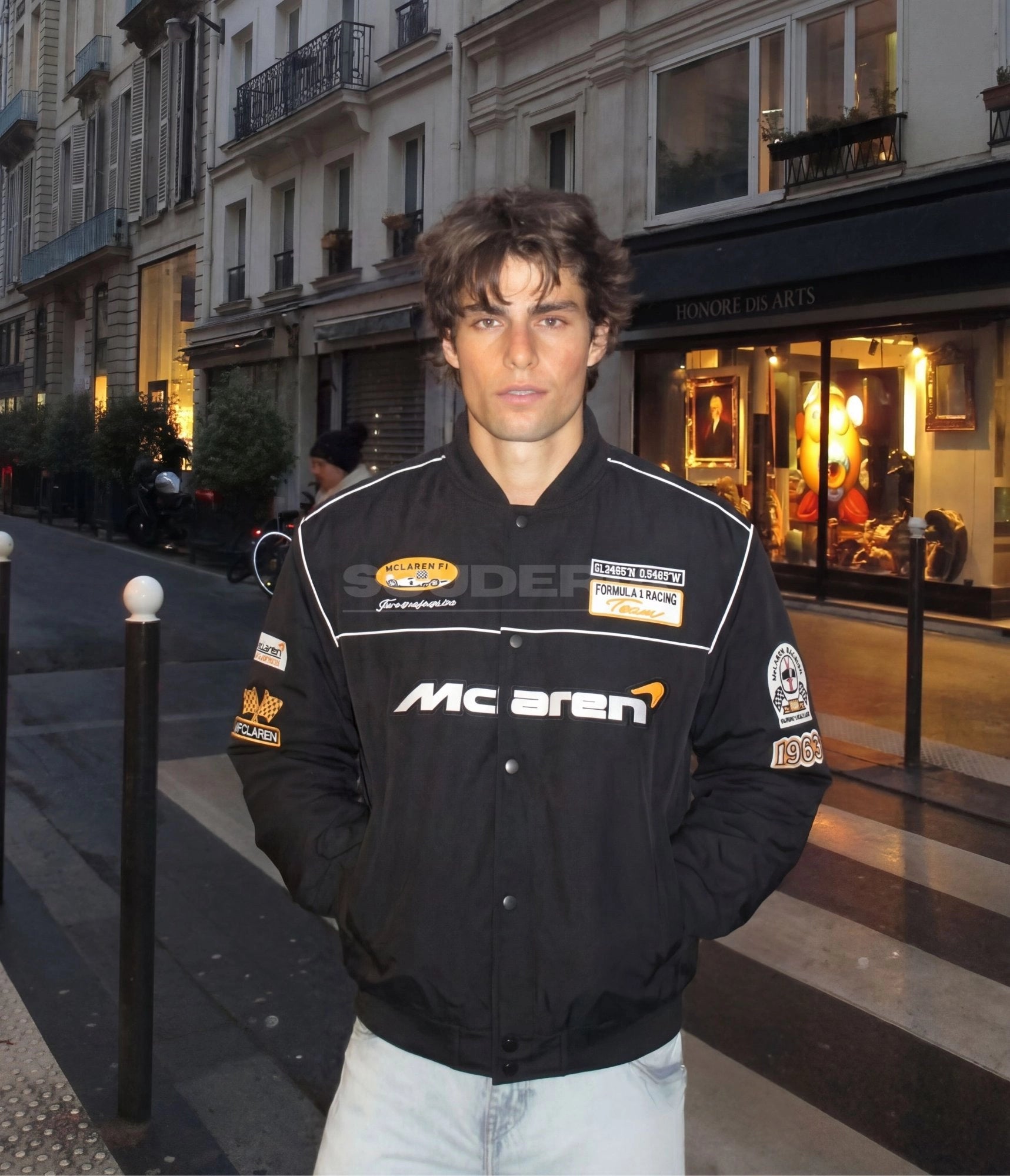 McLaren F1 Racing Jacket black lifestyle men – vintage racing bomber with embroidered McLaren logo, Formula 1 Racing Team and AFCLaren patches styled with jeans in Paris street setting at night