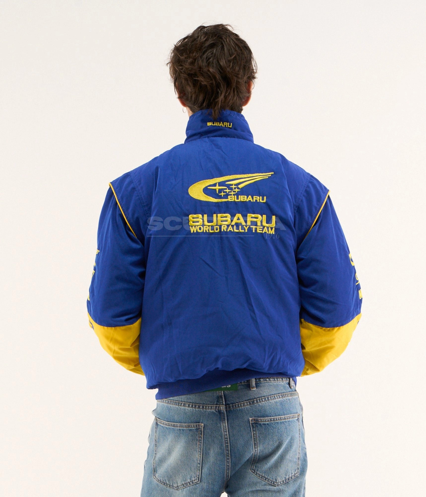 Subaru World Rally Team blue yellow embroidered padded bomber jacket – men back view – Scuderia1976