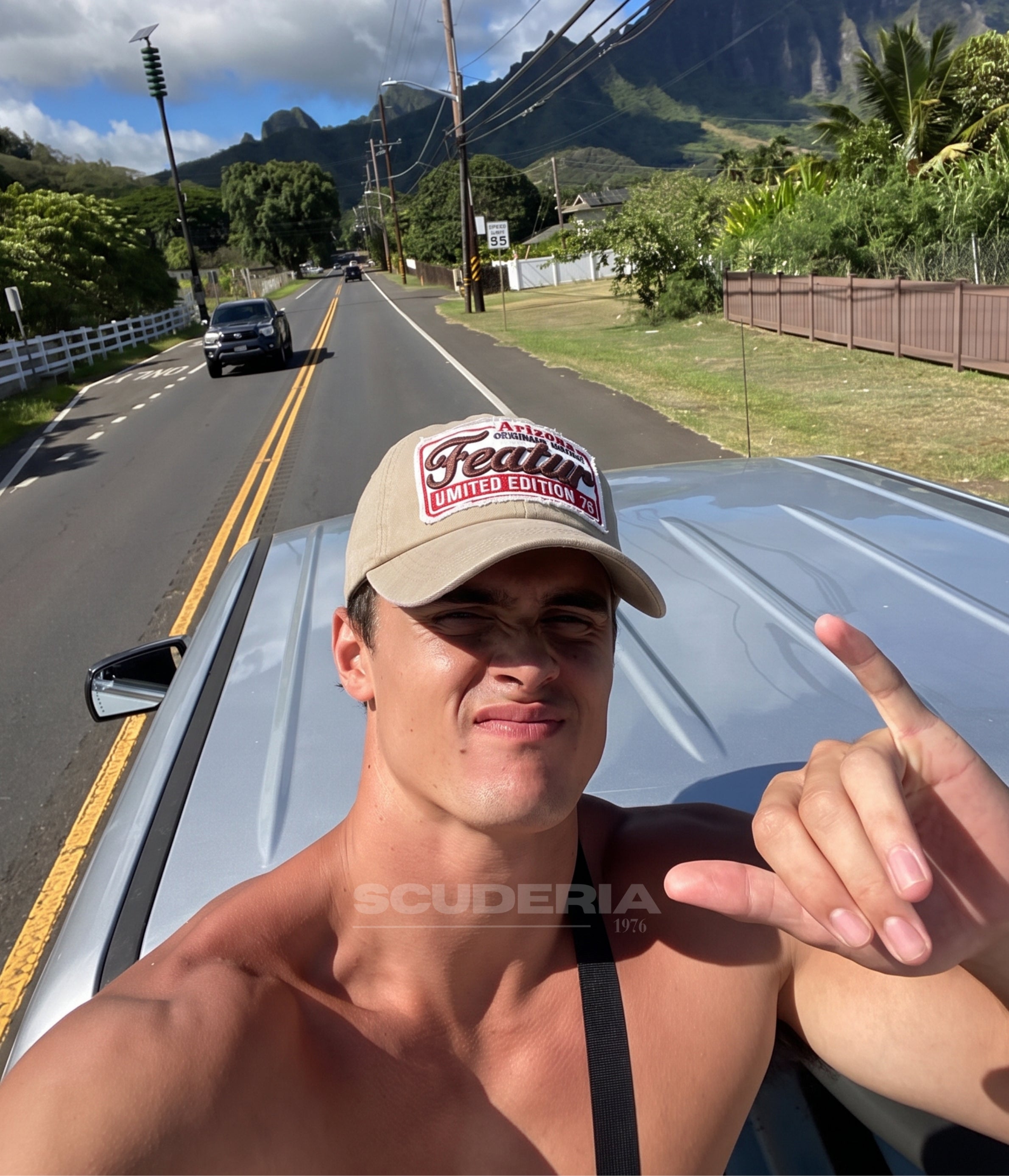 Man wearing the beige Arizona Vintage Patch cap leaning on a car by a coastal road