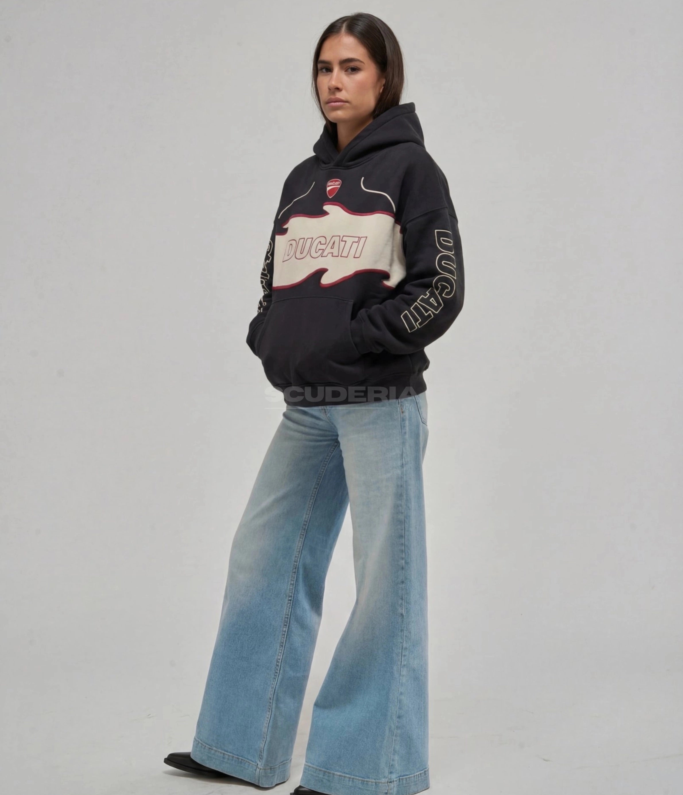 Ducati Racing Hoodie black washed front view woman – vintage oversized motorsport hoodie with Ducati shield patch, Ducati chest logo, Ducati sleeve lettering, styled with wide-leg flare jeans