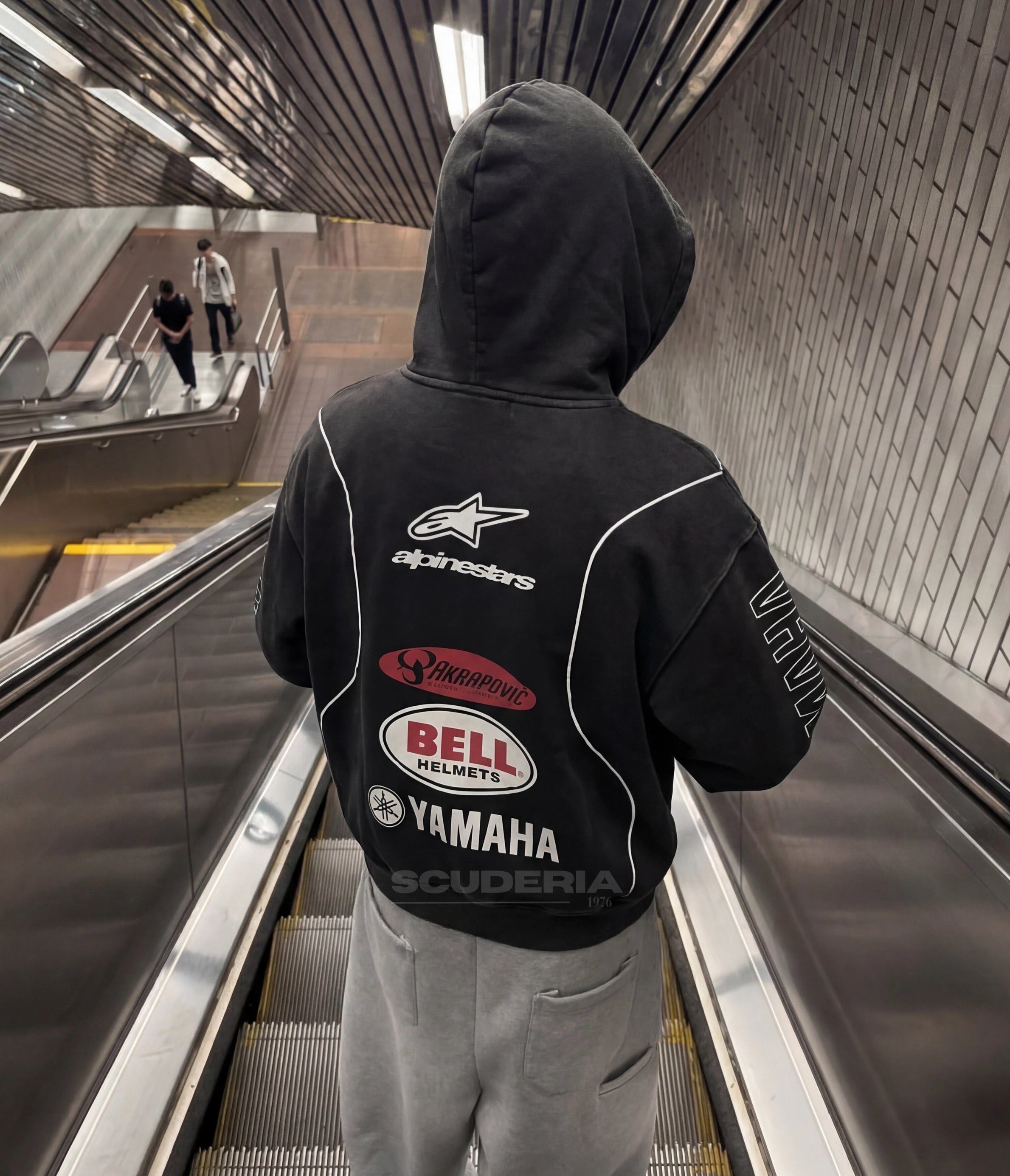 Yamaha Alpinestars Racing Hoodie black washed lifestyle man – vintage oversized motorsport sweatshirt with Alpinestars chest logo, street style with dark baggy jeans and cap outdoors